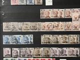 a collection of stamps and stamps on display in a glass case