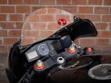 a close up of a motorcycle with a clock on it