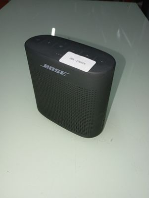 a small black speaker sitting on a table
