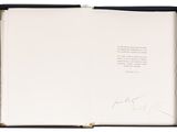 an open book with a handwritten poem in a black box