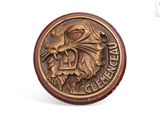 une image représentant une pièce de monnaie en bronze ornée d'une tête de lion