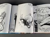 a lot of drawings on the pages of a book