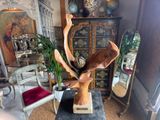 a statue of an antelope on a table in a living room