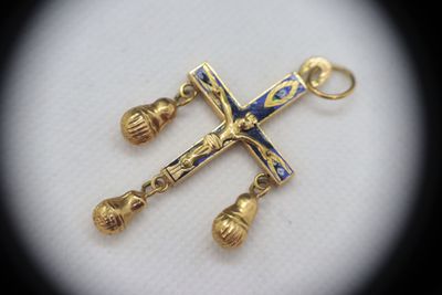 an image of a gold cross with a blue and white cross on it