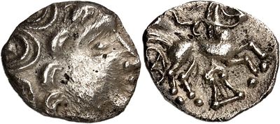 a silver coin with an image of a horse on it