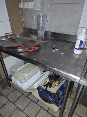 a kitchen with a sink and a metal counter top