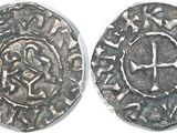 a close up of two silver coins on a white surface