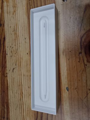 une brosse à dents posée dans une boîte blanche sur une table en bois