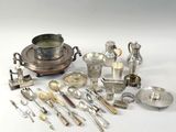 a lot of silver and silverware on a white table