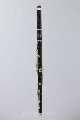 a black and gold clarinet sitting on top of a clear box