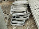 a pile of old metal items on the ground next to a truck