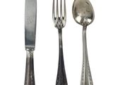 three spoons and a fork on a white background