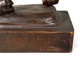 bronze statue of a man on a horse on a wooden base