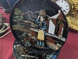 a plate with a picture of a woman on it on a table