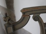 a close up of a chair with a wooden arm rest