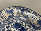 a large blue and white plate with flowers on it