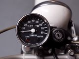 a close up of a motorcycle with a speedometer on it ' s handlebars