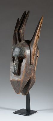 an image of a sculpture of a bird head on a stand