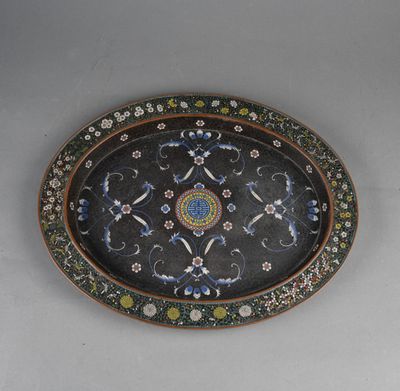 an oval platter with a floral design on it