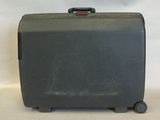 a black suitcase sitting on a white surface