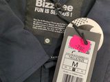 clothing label on a blue jacket hanging on a hanger