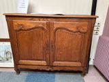 a wooden cabinet that is sitting on the floor