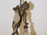 a statue of a man holding a light bulb in his hand