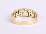 a close up of a gold ring on a white surface