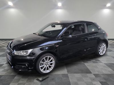 the black car is parked on a checkered floor in the garage