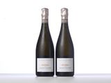 two bottles of wine sitting next to each other on a table