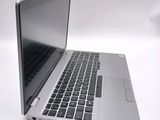 a close up of a laptop computer on a white surface