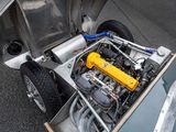 a silver car with a yellow engine in the trunk