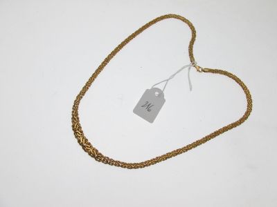 a close up of a gold chain with a tag on it