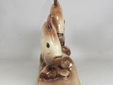 figurine of a man sitting on a bench holding a fish