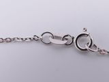 a close up of a silver chain with a clasp on a white surface