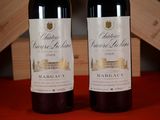 two bottles of wine sitting next to each other on a table
