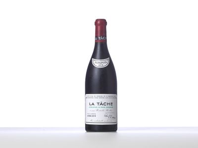bottle of red wine sitting on top of a white table
