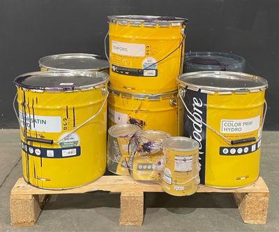 several buckets of paint sitting on top of a wooden pallet