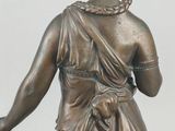 bronze statue of a woman with a dog on a pedestal