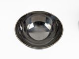 a silver bowl and a black bowl on a white table