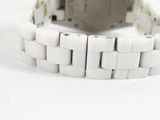 an image of a wrist watch with a white bracelet on a white surface