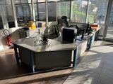 a desk in an office with a lot of windows