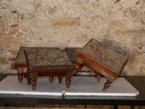 two small tables on a table in front of a brick wall