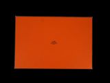 an orange box sitting on top of a black surface