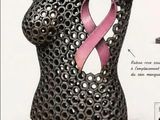 an image of a sculpture of a woman with a pink ribbon on her breast