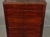 an antique wooden chest of drawers with a marble top