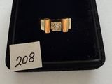 two gold rings with diamonds in a black box with a price tag