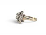 a close up of a silver ring with a flower on it