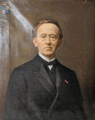 portrait of a man in a suit and tie in front of a brown background