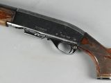 an old gun with a wooden handle on a white surface